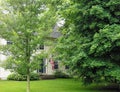 New England Summer House with American Flag Royalty Free Stock Photo