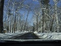 New England winter scene driving - clear roads SNOW covered trees Royalty Free Stock Photo