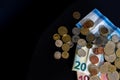 20 and 10 new euro banknote with coins  on black background, top view. Empty space on the left. Royalty Free Stock Photo