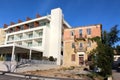 New exclusive five star hotel building next to abandoned destroyed apartment building with broken missing windows Royalty Free Stock Photo