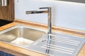 New faucet and stainless steel sink. Modern comfortable kitchen Royalty Free Stock Photo