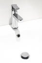 A new faucet on the washstand in a bathroom with white walls. Repair Royalty Free Stock Photo