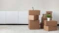 Heap of boxes with belongings stacked in empty living room