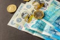 New five sterling pounds note and one pound coin Royalty Free Stock Photo