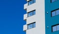 A new flat apartment building close up with clear blue sky in background Royalty Free Stock Photo