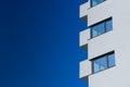 A new flat apartment building close up with clear blue sky in background Royalty Free Stock Photo