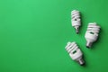New fluorescent lamp bulbs on green background, top view. Space for Royalty Free Stock Photo