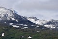 New fresh white snow on jagged mountain top in the arctic circle summer Royalty Free Stock Photo