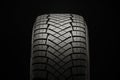 New friction winter tire on a black background, close-up front view Royalty Free Stock Photo