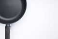 New frying pan on white background, space for text. Top view