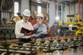 A new generation of engineers in a metal sheet factory. Studying work methods from supervisors or colleagues and studying by Royalty Free Stock Photo