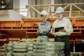 A new generation of engineers in a metal sheet factory. Studying work methods from supervisors or colleagues and studying by Royalty Free Stock Photo