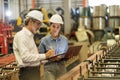 A new generation of engineers in a metal sheet factory. Studying work methods from supervisors or colleagues and studying by Royalty Free Stock Photo