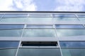 New glass building with reflecting clouds Royalty Free Stock Photo