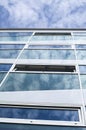 New glass building with reflecting clouds Royalty Free Stock Photo