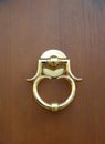 New golden door-handle on wood background Royalty Free Stock Photo