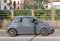 New gray hybrid Fiat 500 parked in an italian urban area. Side view.