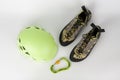 New green climbing helmet and green  HMS carabiner, screw lock snap hook and climbing footwear Royalty Free Stock Photo