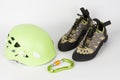 New green climbing helmet and green  HMS carabiner, screw lock snap hook and climbing footwear Royalty Free Stock Photo