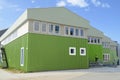 Same green color for house and jacket, colorful green building in Nuuk, Greenland Royalty Free Stock Photo