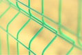 New green grid fence close up. Perspective view. Selective focus Royalty Free Stock Photo