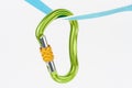 New green HMS carabiner, screw lock snap hook, climbing equipment on sewn loop sling on white background