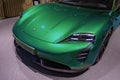 new green Porsche Taycan Turbo S battery-electric sports Car, headlights, sedan Porsche Automobil Holding in showroom, Innovation Royalty Free Stock Photo