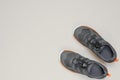 New grey children sneakers on gray background with copy space. Black and white image