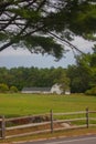 New Hampshire barn framed by trees and field