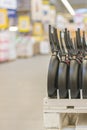 New hang in a row pans in the store. cooking utensils. Row of frying pan on display at kitchen utilities section in supermarket. v