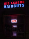 New Hartford, New York - Aug 14, 2019: Low Key Image for the Storefront Neon Lights of the Big League Haircuts, Big League