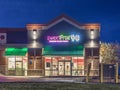 New Hartford, New York - Oct 29, 2019: Night View of Sweet Frog Frozen Yogurt Ice Cream Chain Storefront with Sign and Logo