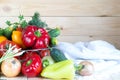 New harvest background with copy space. Fresh vegetables in wicker basket on wooden table. Royalty Free Stock Photo