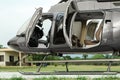 New helicopter with open cabin doors on helipad outdoors