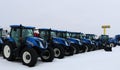 New Holland tractors lined up for sale on grey winter day