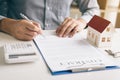 New home buyer signing contract on desk in office room. Royalty Free Stock Photo