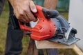 Building contractor worker using hand circular saw to cut boards on a new home constructiion project Royalty Free Stock Photo