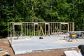 New Home construction site with studs of first wall in place on the concrete Royalty Free Stock Photo