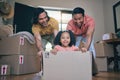 New home, girl and box with parents, push and gay dad with games, portrait and playing on floor with moving. LGBTQ men Royalty Free Stock Photo