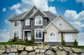 New Home House Custom Cream Rockwork Exterior Dramatic Cloudy Sky Background Royalty Free Stock Photo