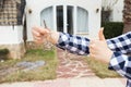 New home, house, property and tenant - Real estate agent handing a house key and showing thumbs up Royalty Free Stock Photo