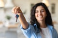 Cheery young woman holding apartment keys, purchasing or renting house, selective focus