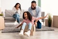 Happy African American family celebrating moving day in new apartment Royalty Free Stock Photo
