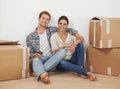 New home, portrait and happy couple with boxes in living room, moving and relax for investment in real estate. Man Royalty Free Stock Photo