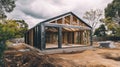 New home structure under construction surrounded by trees and clouds Royalty Free Stock Photo