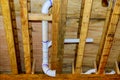 New home under construction plumbing drain pipes inside a house frame Royalty Free Stock Photo