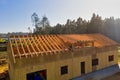 New home under construction in rural area with pine trees around it Royalty Free Stock Photo