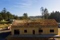New home under construction in rural area with pine trees around it Royalty Free Stock Photo