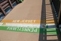 New Hope, Pennsylvania - August 25, 2019: The Pennsylvania, New Jersey state line painted on the sidewalk walkway in the meddle of