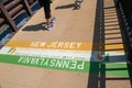 New Hope, Pennsylvania - August 25, 2019: People`s feet are seen walking near the Pennsylvania - New Jersey state line on a bridg